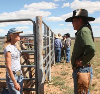 Navajo activist Leland Grass (right) confronts horse buyer Jeanne Collom.